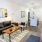 couch and chair in living area, kitchen in background